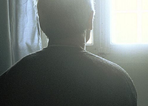 Picture of the back of a man staring at the window