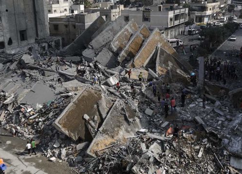 Gaza City, 2014. Palestinians check the remains of Al-Basha, a building that was destroyed by an Israeli air strike. 