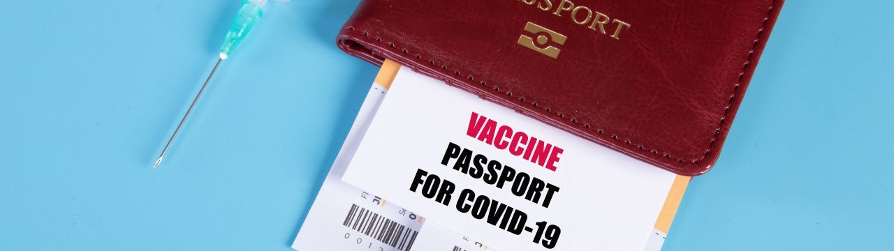 A photo with a passport and COVID-19 vaccine certificate