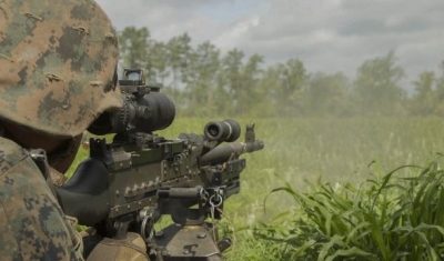 A U.S. Marine fires an M240B machine gun at a target during a company attack exercise at Fort A.P. Hill