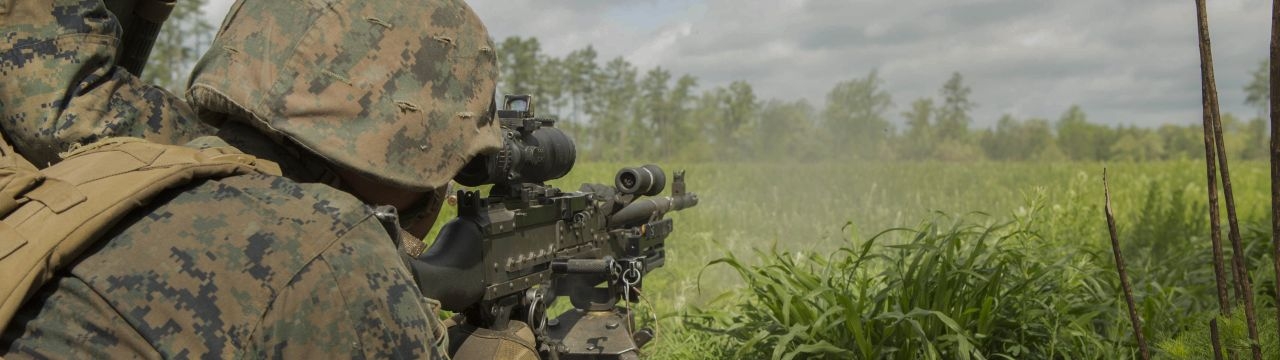 A U.S. Marine fires an M240B machine gun at a target during a company attack exercise at Fort A.P. Hill