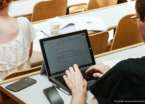 LLM student taking notes during a course on his laptop
