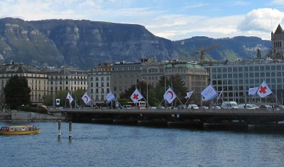 Mont-Blanc bridge in Geneva with red Cross' flags