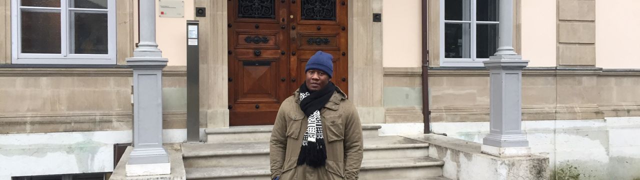 Tafadzwa Christmas, a Zimbabwean student enrolled in the Master of Advanced Studies in Transitional Justice, Human Rights and the Rule of Law in front of the Villa Moynier, the Geneva Academy's headquarters