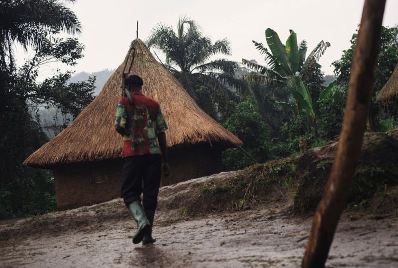 A militia man of an armed group carries an AK-47 in the village of Kalungu. 