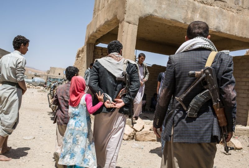 Yemen, governorate of Amran, Harf Sufyan, in March, 2018. Armed men of kalashnikov walk in the direction of a building 