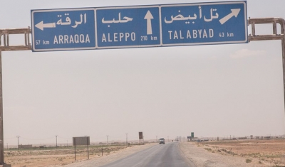 Syria - Kurdish province - Road to Raqqa. A road sign from the north indicating an important crossroads to come. Raqqa is located in the center of Syria.