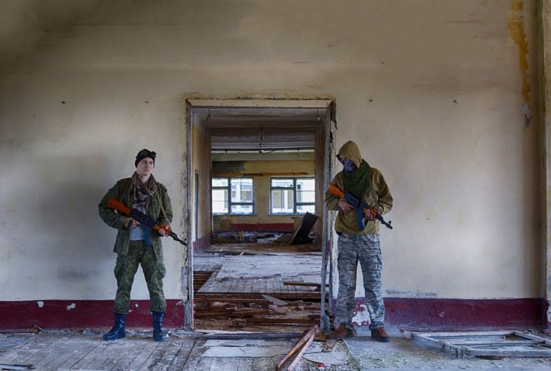 Two mercenaries guarding a building